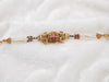 Traditional Temple-Style Multi-Strand Pearl Bracelet with Gemstone Centerpiece