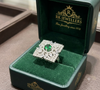A luxurious, contemporary statement ring featuring a striking green gemstone.