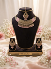 A stunning antique-style necklace set featuring sparkling stonework and delicate pastel pink bead accents.