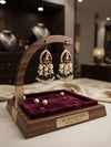 Handcrafted teardrop earrings featuring a vibrant green pink Red center stone accented with delicate ruby-toned floral motifs